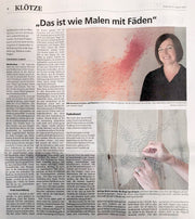 Portrait der Fadenkünstlerin Sandra Dörwald mit einem ihrer abstrakten Fadenbilder aus Nägeln und Fäden.